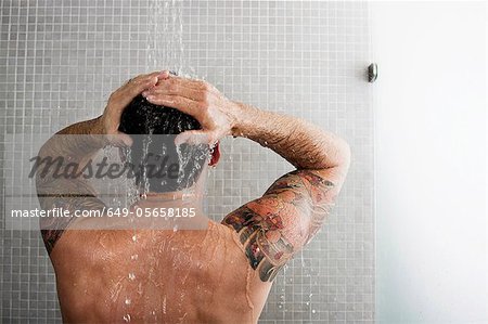 Man washing his hair in shower