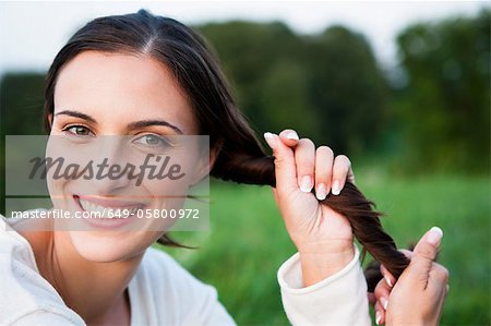 Smiling woman playing with her hair