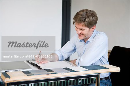 Smiling businessman working at desk