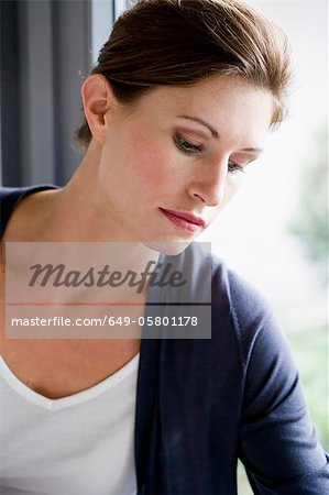 Close up of woman leaning on window