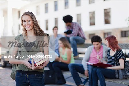 Student carrying books on campus