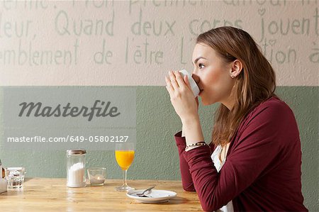 Woman having cup of coffee in cafe