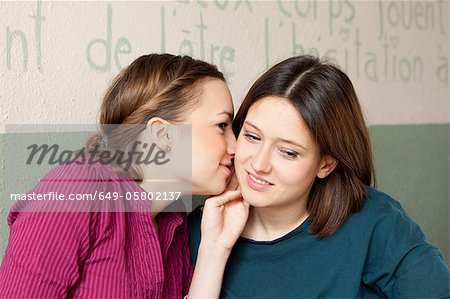 Women whispering to each other