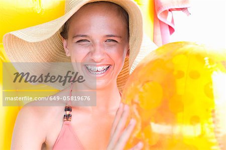 Teenage girl in braces wearing sunhat