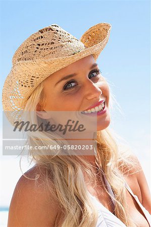 Smiling woman wearing sunhat outdoors