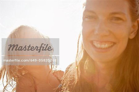 Mother and daughter smiling outdoors