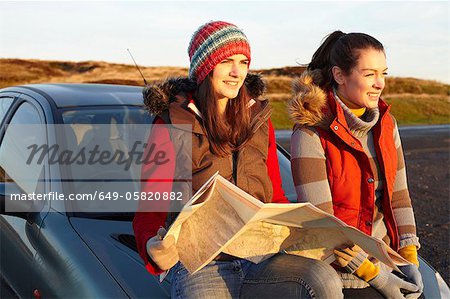 Women reading map by car