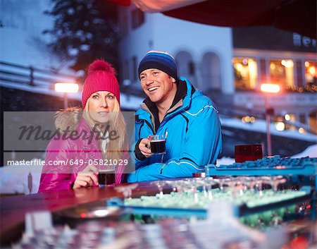 Couple having coffee outdoors in winter