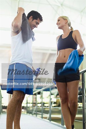 Smiling couple talking in gym