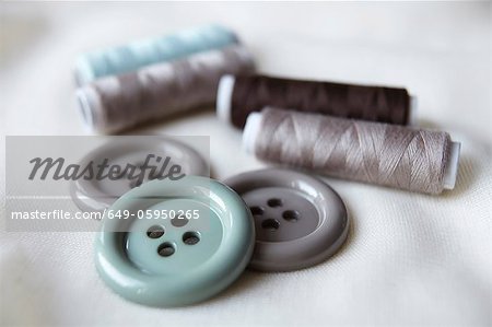 Close up of buttons and spools of thread