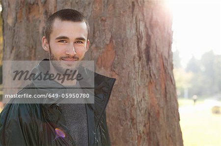 Smiling man standing in park