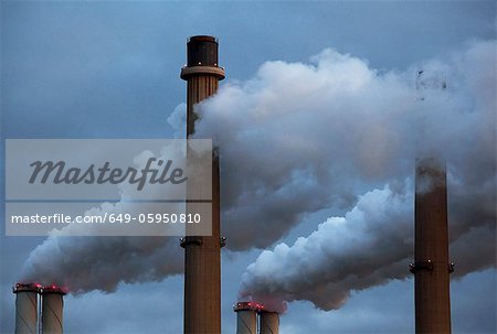 Smoke pouring from factory smokestacks