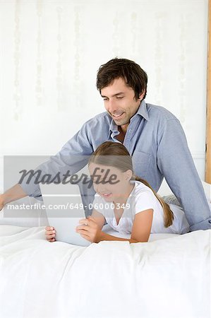 Father and daughter using tablet