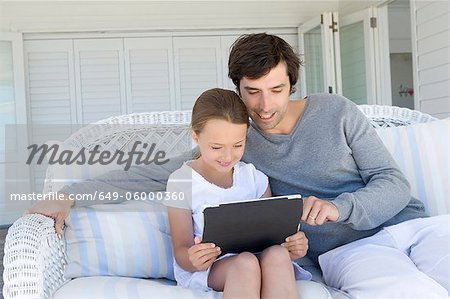 Father and daughter using tablet