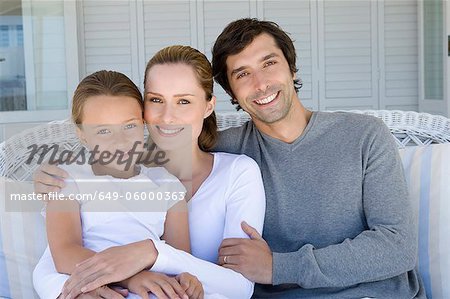 Family relaxing on sofa together