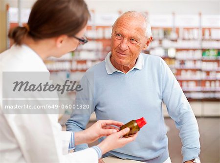 Pharmacist talking to patient in store Pharmacist talking to patient in store