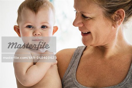 Smiling mother holding baby girl