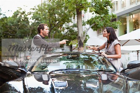 Couple arguing over sports car