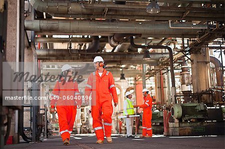 Workers walking at oil refinery