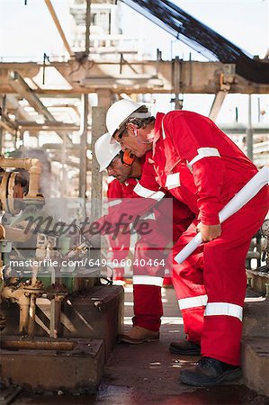 Workers examining equipment on site