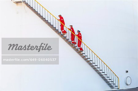 Workers on steps at chemical plant