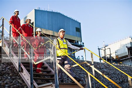 Workers on steps at chemical plant