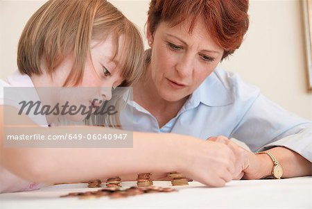 Mother and daughter counting coins