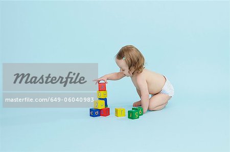 Baby girl playing with colored blocks