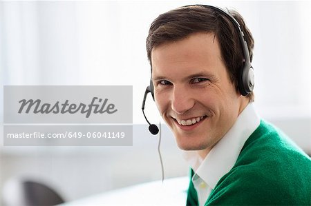 Businessman wearing headset in office