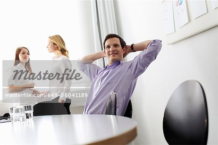 Businessman stretching in office