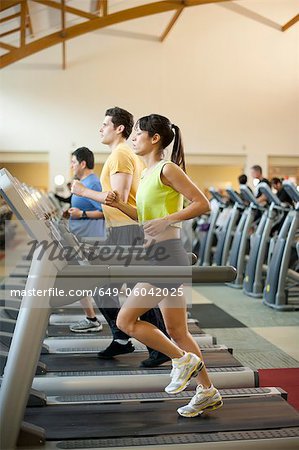 People using treadmills in gym