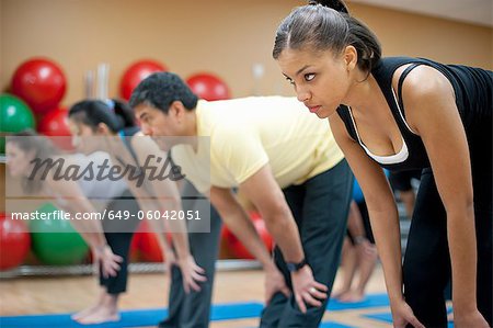 People practicing yoga in studio