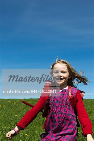 Smiling girl wearing backpack outdoors