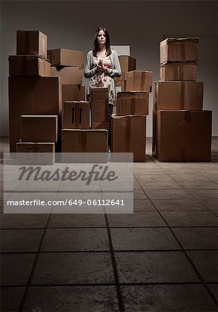 Teenage girl in pile of cardboard boxes