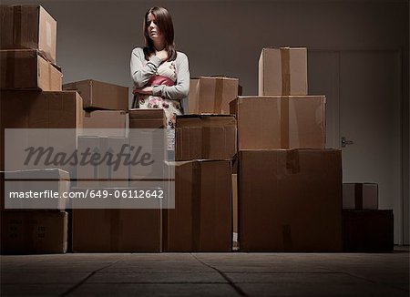 Teenage girl in pile of cardboard boxes