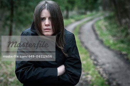 Teenage girl wrapped in parka outdoors
