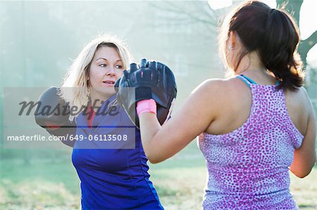 Boxer training with coach outdoors