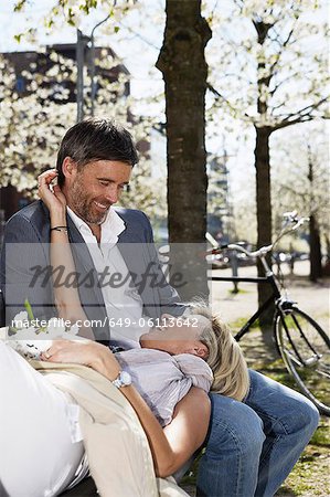 Couple relaxing on park bench