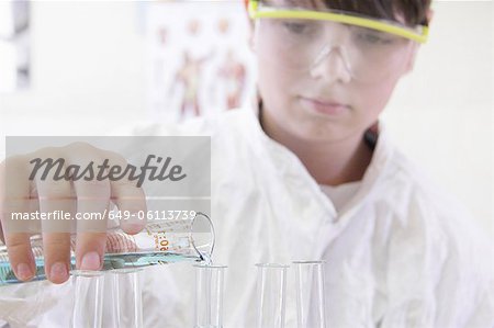 Student pouring liquid into test tube