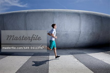 Man running in industrial area