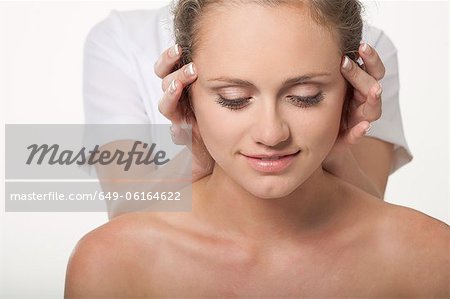 Smiling woman having scalp massage