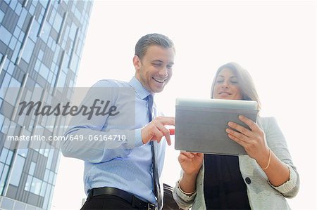 Business people using tablet computer Business people using tablet computer