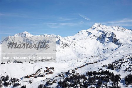 Trees and ski slopes on snowy mountains