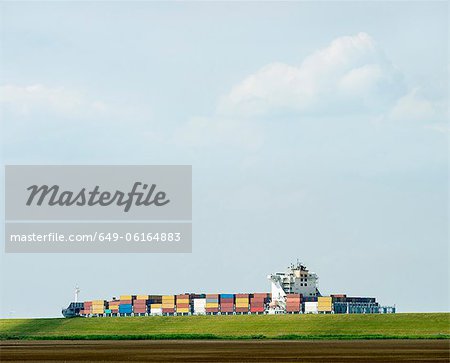 Containers in shipyard by rural field