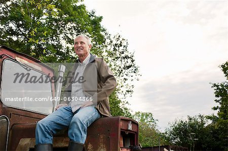 Man sitting on vintage tractor outdoors