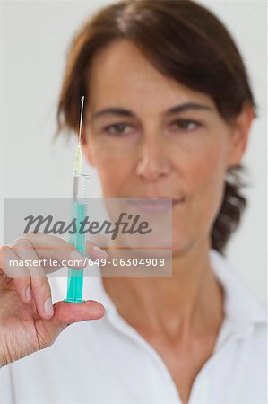 Close up of doctor preparing syringe