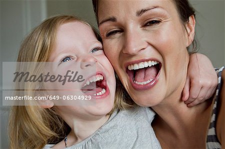 Close up of mother and daughter laughing