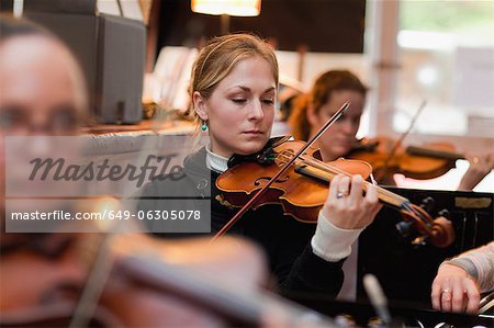 Violin player practicing with group