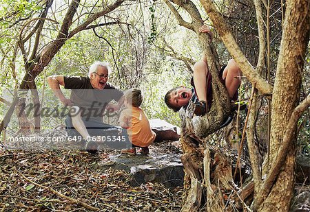 Father and his sons playing in the forest