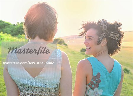 Smiling women standing in meadow